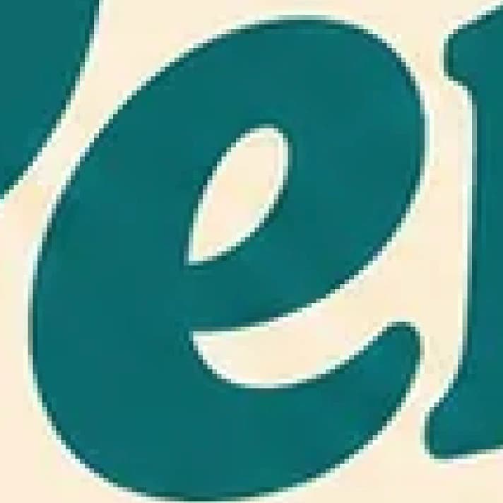 A zoomed-in crop of a logo as a raster image, with soft, blurry, pixelated edges
